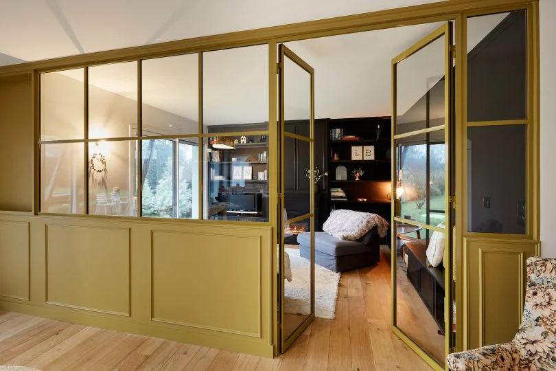 Verrière jaune kiwi sur mesure entre le salon et la salle à manger d’une maison de Baden